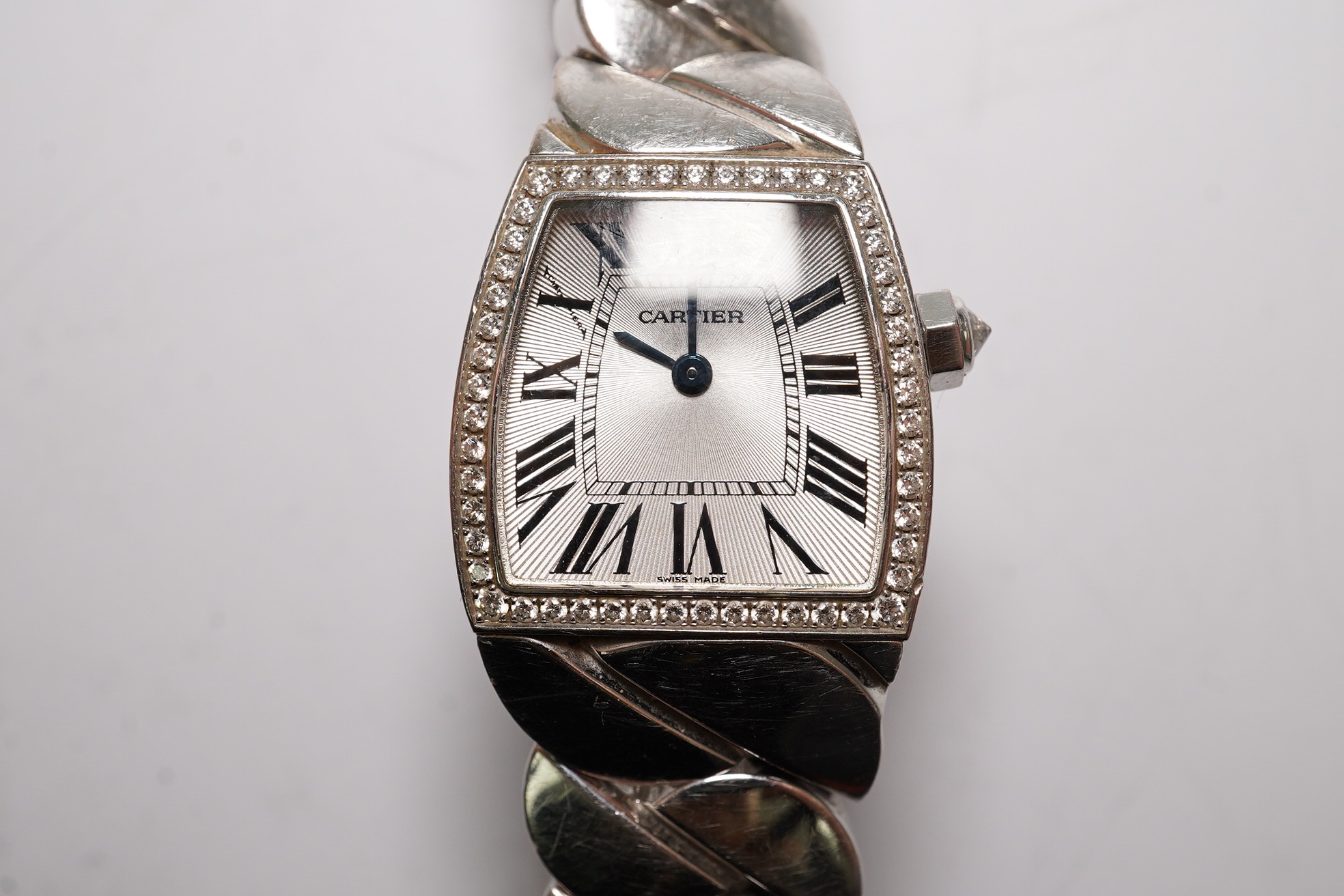 A lady's recent 18ct white gold and diamond set Cartier La Dona quartz wrist watch, on an 18ct white gold Cartier bracelet